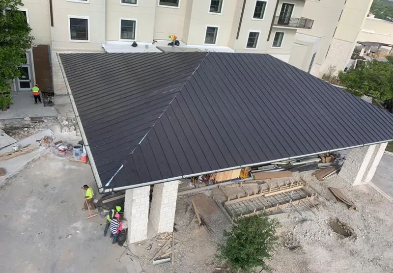Metal roofing installation team working on a commercial building in Tucson